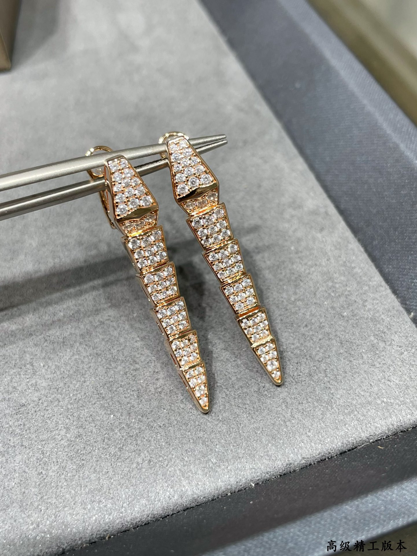 B*l*ai full-level drill snake earrings